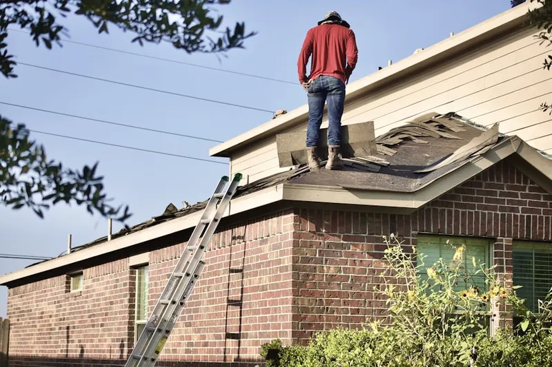 Professional roofer working on a residential roof in New Lisbon